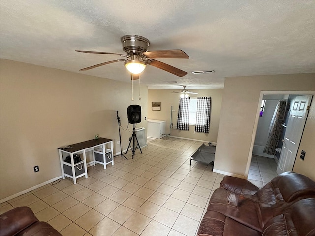 5549 NW 64th St, Ocala, FL 34482 - living room featuring ceiling fan, light tile patterned floors, baseboards, and a textured ceiling