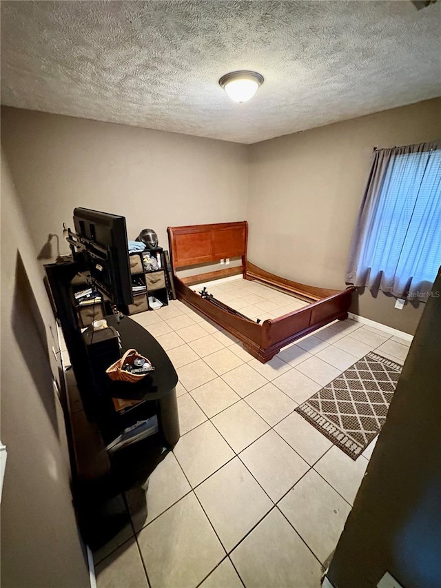 5549 NW 64th St, Ocala, FL 34482 - bedroom with light tile patterned floors and a textured ceiling