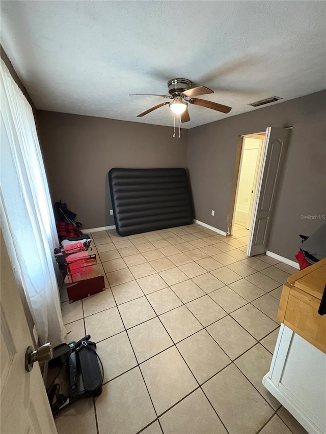 5549 NW 64th St, Ocala, FL 34482 - living area featuring ceiling fan, light tile patterned floors, baseboards, and a textured ceiling