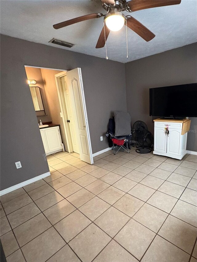 5549 NW 64th St, Ocala, FL 34482 - living area featuring light tile patterned floors, a ceiling fan, and baseboards