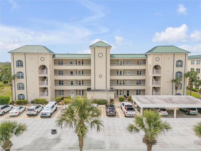 420 Bouchelle Dr Unit 204, New Smyrna Beach, FL 32169 - view of apartment building / complex with covered and uncovered parking