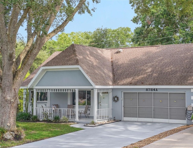 view of front of home featuring roof with shingles, covered porch, a garage, stucco siding, and concrete driveway
