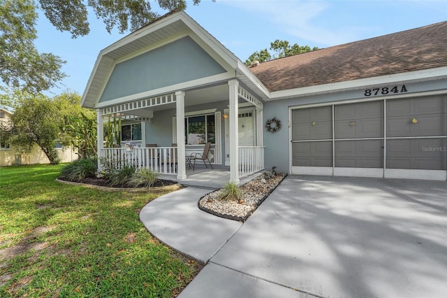 view of front facade with covered porch, an attached garage, a front lawn, a shingled roof, and stucco siding
