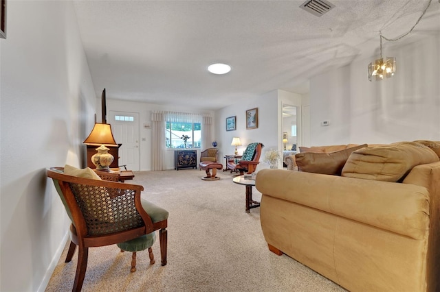 carpeted living room with a chandelier