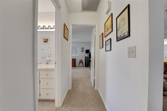 hall featuring light carpet