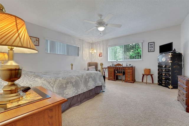 bedroom featuring carpet floors, a textured ceiling, and a ceiling fan