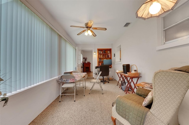 living area featuring a desk, a ceiling fan, and carpet flooring