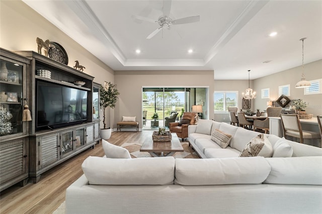 8606 SW 61st Loop, Ocala, FL 34481 - living room with a chandelier, ceiling fan, light wood-style flooring, a raised ceiling, and recessed lighting