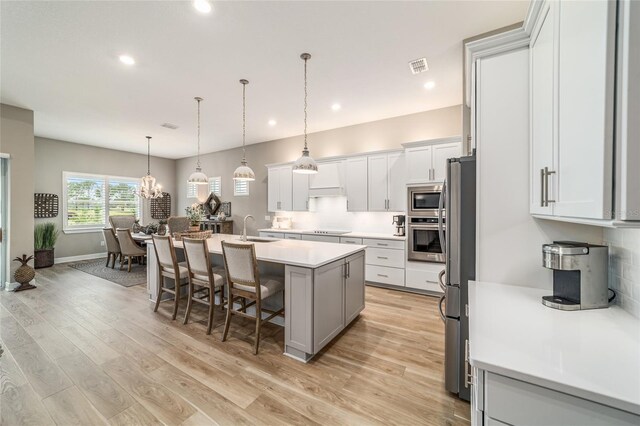 8606 SW 61st Loop, Ocala, FL 34481 - kitchen featuring stainless steel appliances, a sink, a kitchen island with sink, recessed lighting, and light countertops