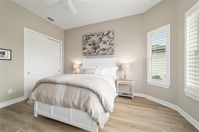 8606 SW 61st Loop, Ocala, FL 34481 - bedroom with light wood finished floors, a closet, multiple windows, and baseboards