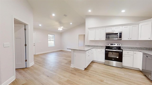 24128 SW S Lakes Ct, Dunnellon, FL 34431 - kitchen featuring stainless steel appliances, a peninsula, vaulted ceiling, a ceiling fan, and white cabinetry