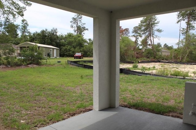 view of green lawn featuring a patio
