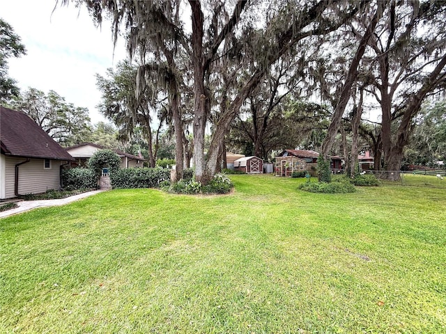 7023 W Riverbend Rd, Dunnellon, FL 34433 - view of yard with a shed and an outbuilding