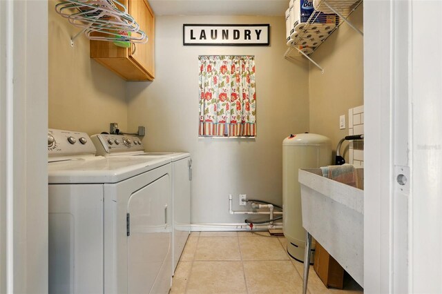 3020 E Scofield St, Inverness, FL 34453 - laundry area featuring washer and clothes dryer, cabinet space, light tile patterned floors, and baseboards
