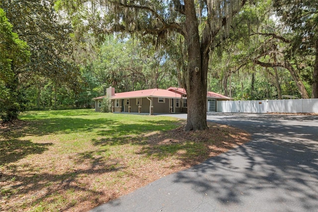 4010 SW 7th Avenue Rd, Ocala, FL 34471 - view of front facade with asphalt driveway and a chimney
