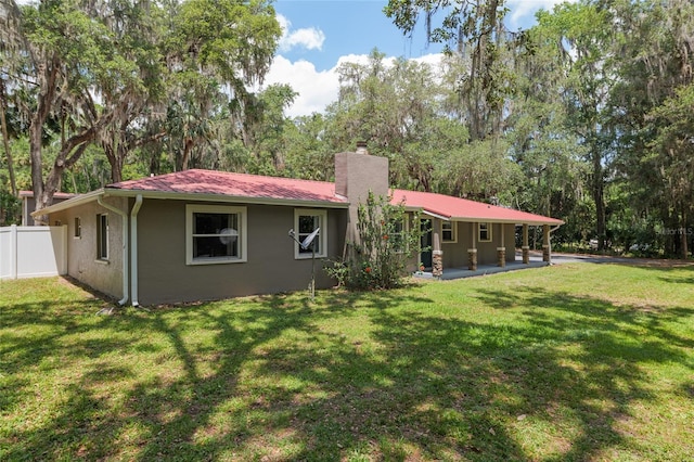 4010 SW 7th Avenue Rd, Ocala, FL 34471 - rear view of property with a chimney, a patio area, metal roof, and stucco siding