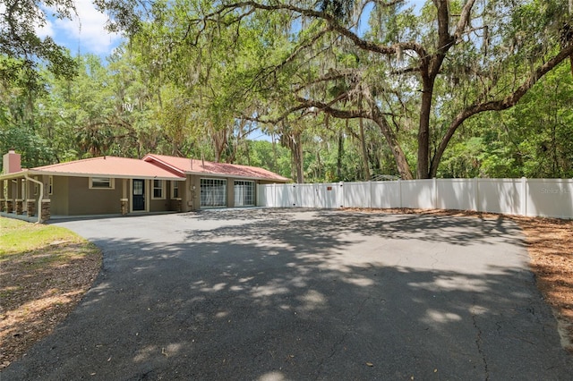4010 SW 7th Avenue Rd, Ocala, FL 34471 - view of side of home with asphalt driveway and a chimney