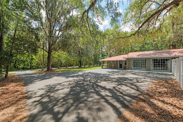 4010 SW 7th Avenue Rd, Ocala, FL 34471 - view of front of property featuring metal roof and a forest view