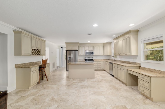4010 SW 7th Avenue Rd, Ocala, FL 34471 - kitchen featuring stainless steel appliances, cream cabinetry, a sink, crown molding, and a center island
