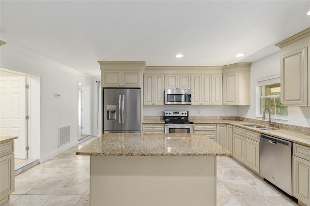 4010 SW 7th Avenue Rd, Ocala, FL 34471 - kitchen with stainless steel appliances, cream cabinets, a sink, light stone countertops, and ornamental molding