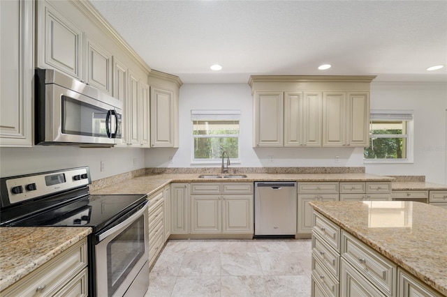 4010 SW 7th Avenue Rd, Ocala, FL 34471 - kitchen with stainless steel appliances, a sink, cream cabinets, plenty of natural light, and recessed lighting