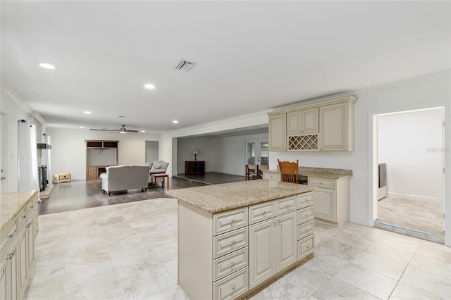 4010 SW 7th Avenue Rd, Ocala, FL 34471 - kitchen featuring cream cabinetry, crown molding, a ceiling fan, a center island, and recessed lighting