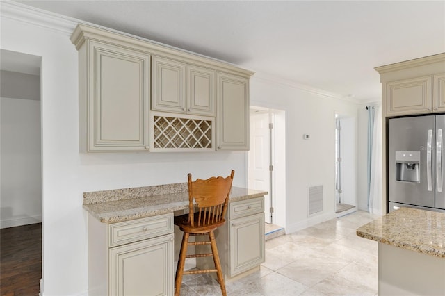 4010 SW 7th Avenue Rd, Ocala, FL 34471 - kitchen featuring cream cabinets, stainless steel refrigerator with ice dispenser, ornamental molding, light stone counters, and baseboards