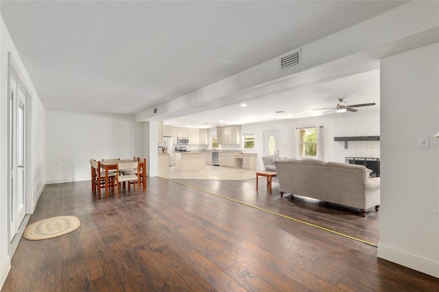 4010 SW 7th Avenue Rd, Ocala, FL 34471 - living room featuring dark wood finished floors, a ceiling fan, a brick fireplace, baseboards, and recessed lighting