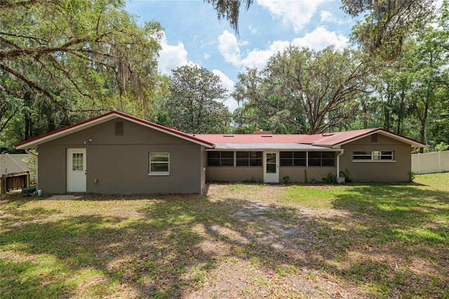 4010 SW 7th Avenue Rd, Ocala, FL 34471 - back of house with metal roof, a sunroom, and stucco siding
