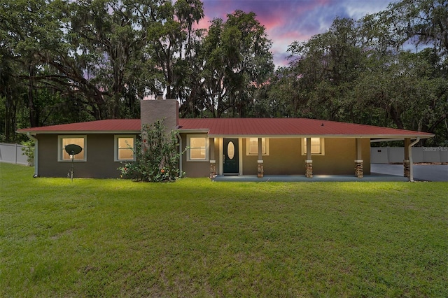 4010 SW 7th Avenue Rd, Ocala, FL 34471 - view of front of home with a chimney, metal roof, stucco siding, and a carport