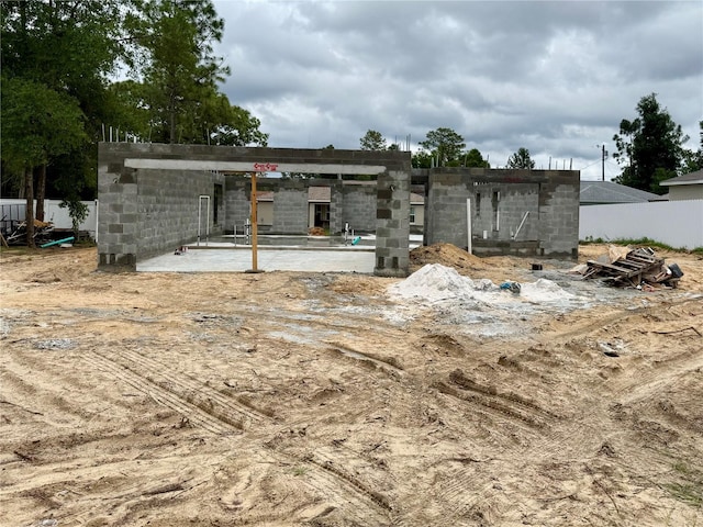 back of house with concrete block siding