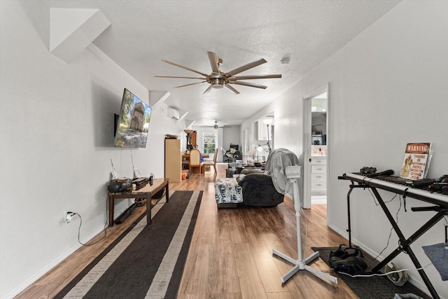 7059 N Lecanto Hwy, Hernando, FL 34442 - workout area with a ceiling fan, light wood-style floors, a textured ceiling, and baseboards