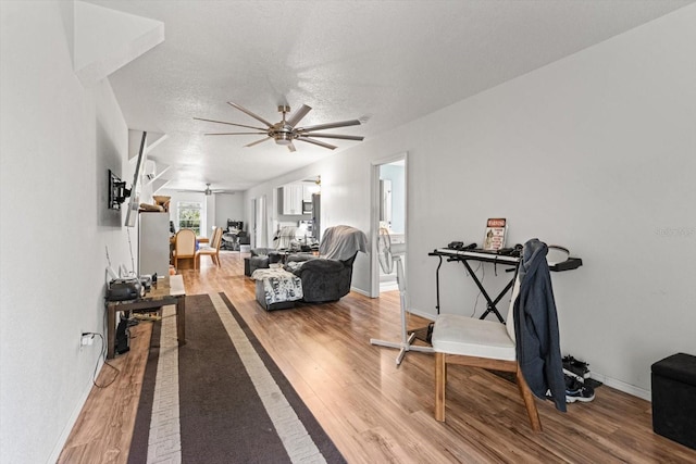 7059 N Lecanto Hwy, Hernando, FL 34442 - exercise area with a ceiling fan, light wood-style flooring, baseboards, and a textured ceiling