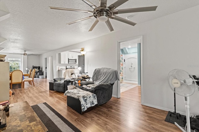 7059 N Lecanto Hwy, Hernando, FL 34442 - living room featuring ceiling fan, wood finished floors, a textured ceiling, and baseboards