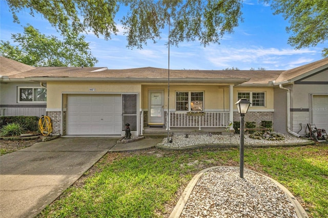 9667 SW 94th Ct Unit C, Ocala, FL 34481 - ranch-style house featuring an attached garage, covered porch, driveway, stucco siding, and brick siding