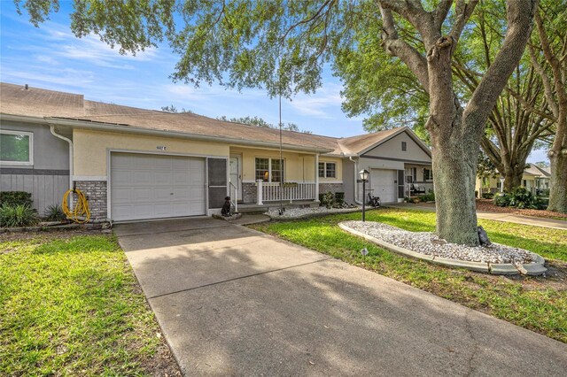 9667 SW 94th Ct Unit C, Ocala, FL 34481 - ranch-style home featuring a garage, stucco siding, concrete driveway, and a front yard
