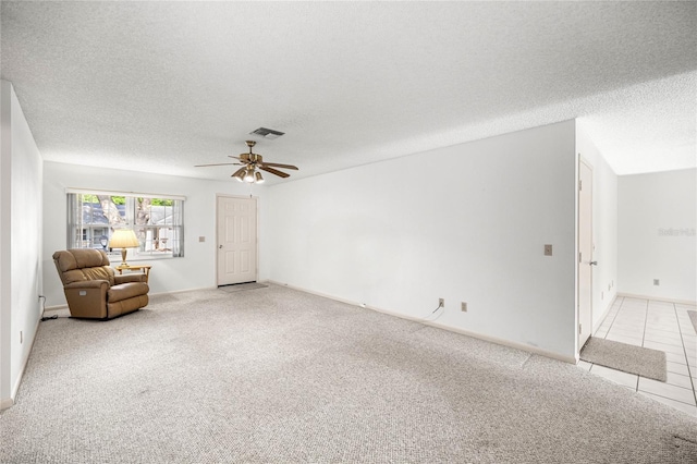 9667 SW 94th Ct Unit C, Ocala, FL 34481 - unfurnished living room featuring a textured ceiling, ceiling fan, light carpet, and baseboards