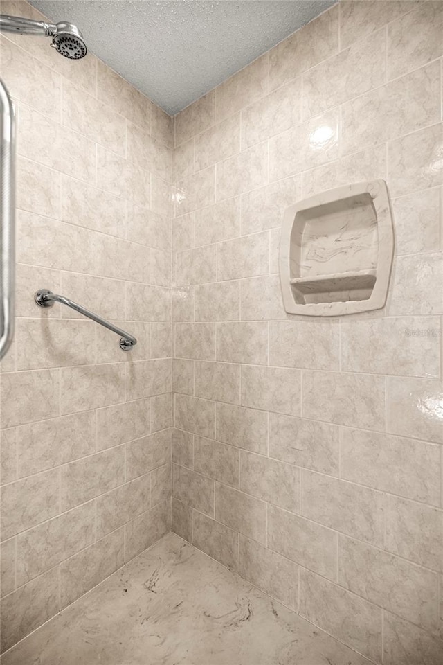 9667 SW 94th Ct Unit C, Ocala, FL 34481 - full bathroom featuring tiled shower and a textured ceiling