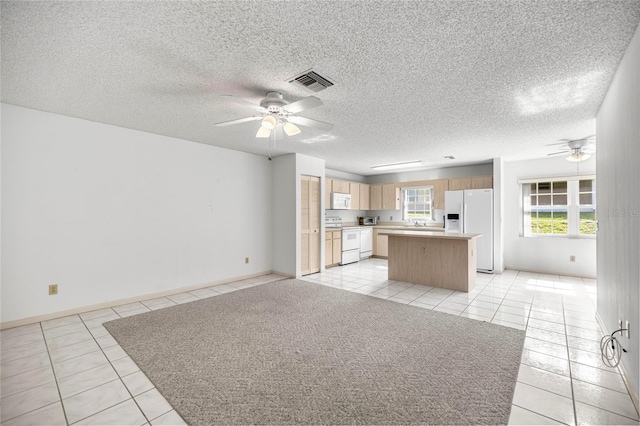 9667 SW 94th Ct Unit C, Ocala, FL 34481 - kitchen featuring white appliances, a ceiling fan, light tile patterned floors, and a textured ceiling