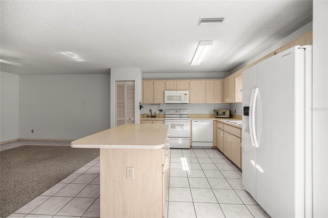 9667 SW 94th Ct Unit C, Ocala, FL 34481 - kitchen with white appliances, light brown cabinetry, light countertops, a textured ceiling, and a center island