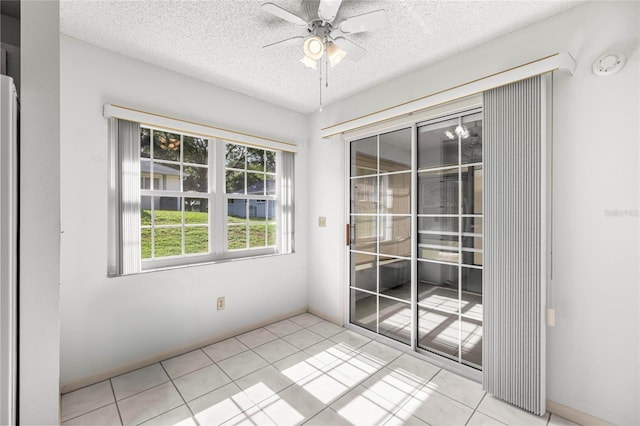 9667 SW 94th Ct Unit C, Ocala, FL 34481 - unfurnished room with a textured ceiling, a ceiling fan, light tile patterned floors, and a smoke detector