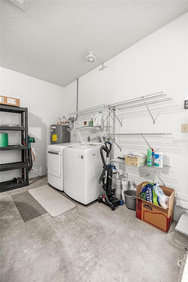 9667 SW 94th Ct Unit C, Ocala, FL 34481 - laundry room with independent washer and dryer, concrete block wall, a textured ceiling, and water heater