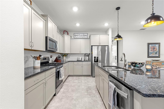 7641 SW 63rd Lane Rd, Ocala, FL 34474 - kitchen with stainless steel appliances, a sink, tasteful backsplash, a kitchen island with sink, and hanging light fixtures