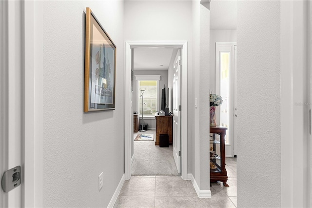 7641 SW 63rd Lane Rd, Ocala, FL 34474 - hallway featuring light tile patterned floors, a textured wall, and baseboards