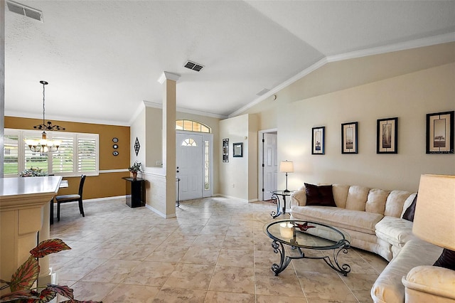 living room featuring ornamental molding, vaulted ceiling, a chandelier, and baseboards