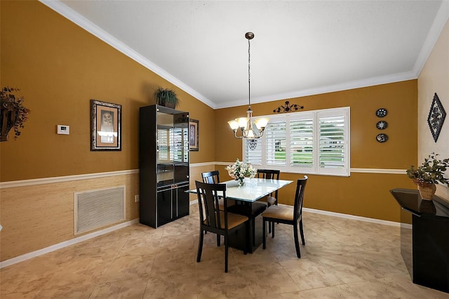 dining room featuring a chandelier, ornamental molding, and baseboards