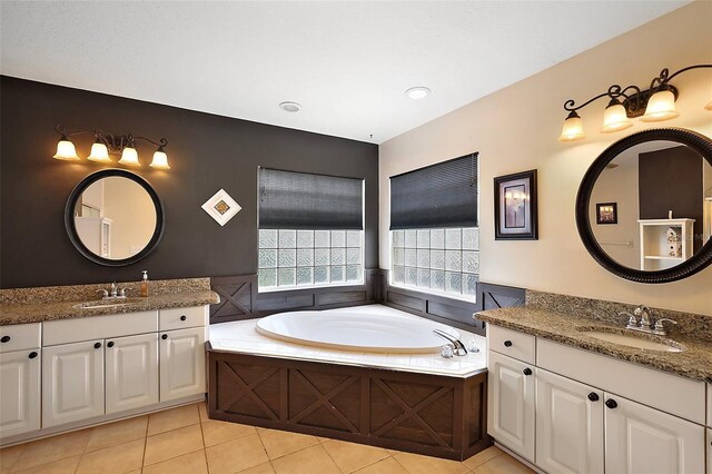 bathroom featuring tile patterned floors, two vanities, and a garden tub