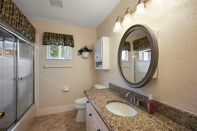 full bathroom with toilet, tile patterned flooring, enclosed tub / shower combo, and vanity