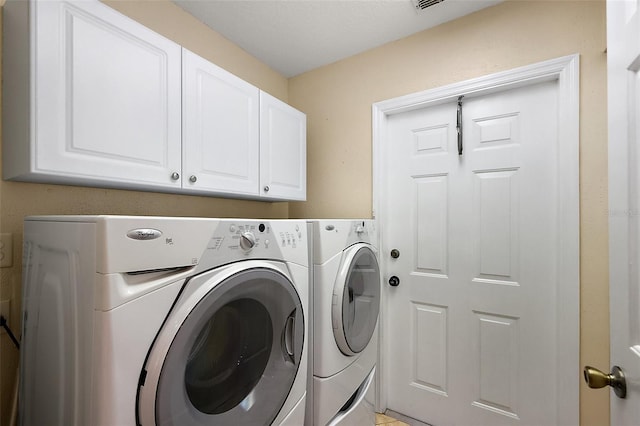 laundry room featuring cabinet space and washing machine and clothes dryer