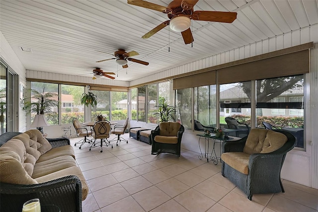 sunroom / solarium with a ceiling fan, an outdoor living space, and plenty of natural light